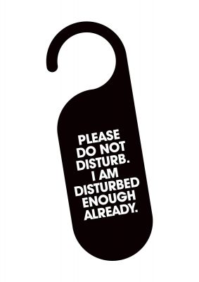 An unframed print of please do not disturb quote in typography in white and black accent colour