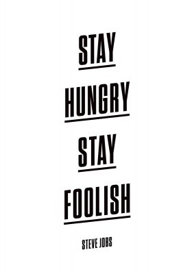 An unframed print of stay hungry stay foolish quote in typography in white and black accent colour