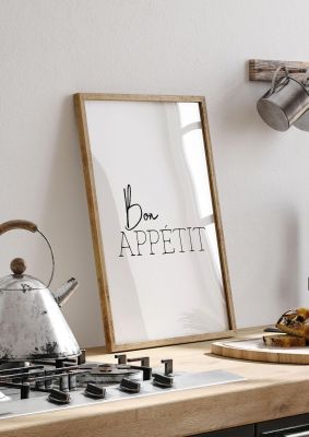 An unframed print of bon appetit quote in typography in white and black accent colour