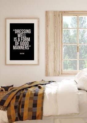 An unframed print of dressing well is a form of good manners quote in typography in black and white accent colour