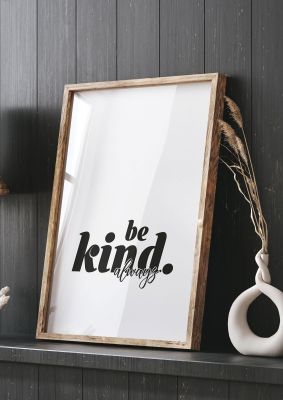 An unframed print of be kind always quote in typography in white and black accent colour
