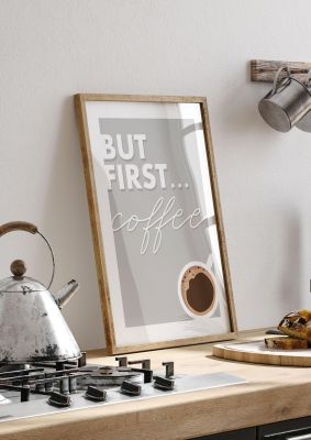 An unframed print of but first coffee quote in typography in grey and white accent colour