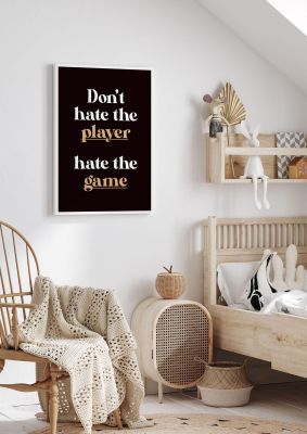 An unframed print of dont hate the player quote in typography in black and gold accent colour