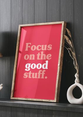 An unframed print of focus on the good stuff quote in typography in red and white accent colour
