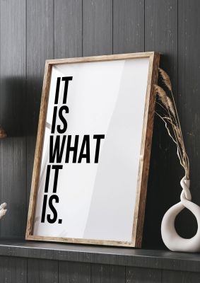 An unframed print of it is what it is quote in typography in white and black accent colour