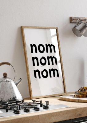 An unframed print of nom nom nom funny slogans in typography in white and black accent colour