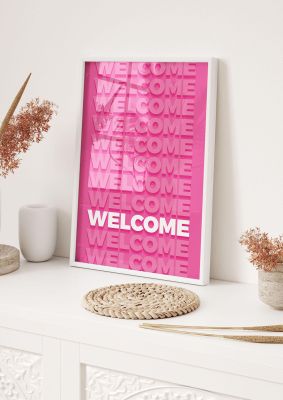An unframed print of welcome quote in typography in pink and white accent colour