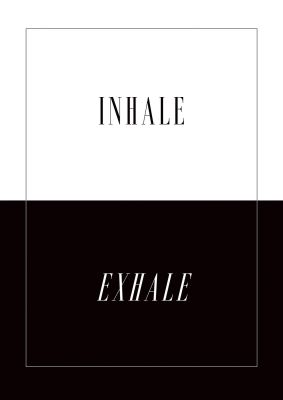 An unframed print of inhale exhale graphical in typography in black and white accent colour