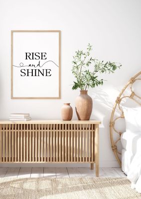 An unframed print of rise and shine quote in typography in white and black accent colour
