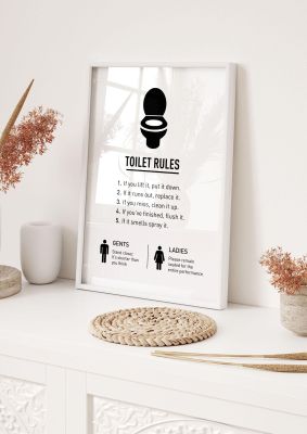 An unframed print of toilet rules quote in typography in white and black accent colour