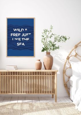 An unframed print of wild and free just like the sea quote in typography in blue and white accent colour