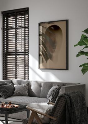 An unframed print of surrealist face leaf fade in golden sand graphical illustration in brown