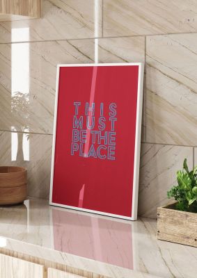 An unframed print of this must be the place lyric quote in typography in red and blue accent colour