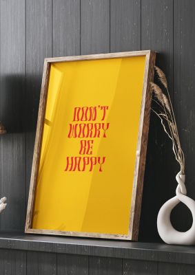 An unframed print of dont worry be happy quote in typography in orange and red accent colour