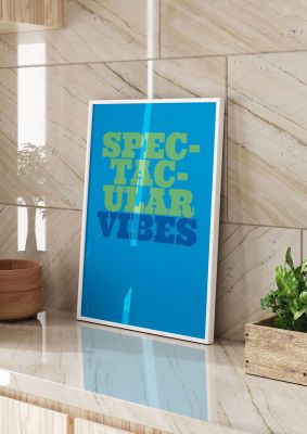 An unframed print of spectacular vibes quote in typography in blue and green accent colour