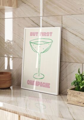 An unframed print of but first champagne funny slogans in typography in beige and pink accent colour