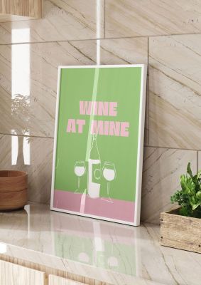 An unframed print of wine at mine funny slogans in typography in green and pink accent colour