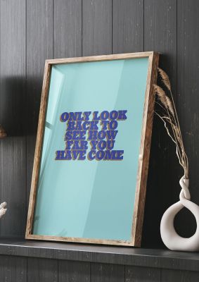 An unframed print of look back inspirational quote in typography in blue and green accent colour