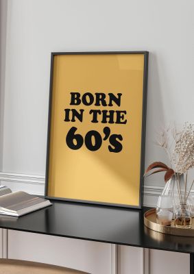 An unframed print of born in the 60's graphical in typography in orange and black accent colour