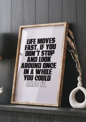 An unframed print of life moves fast inspirational quote in typography in beige and black accent colour
