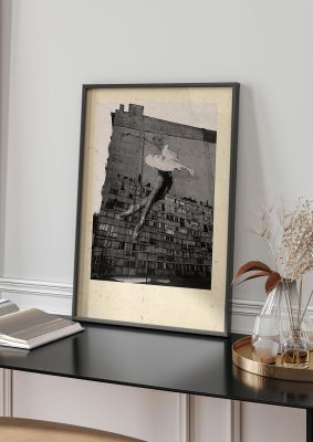 An unframed print of dancing large mosiac on side of building graphical photograph in monochrome